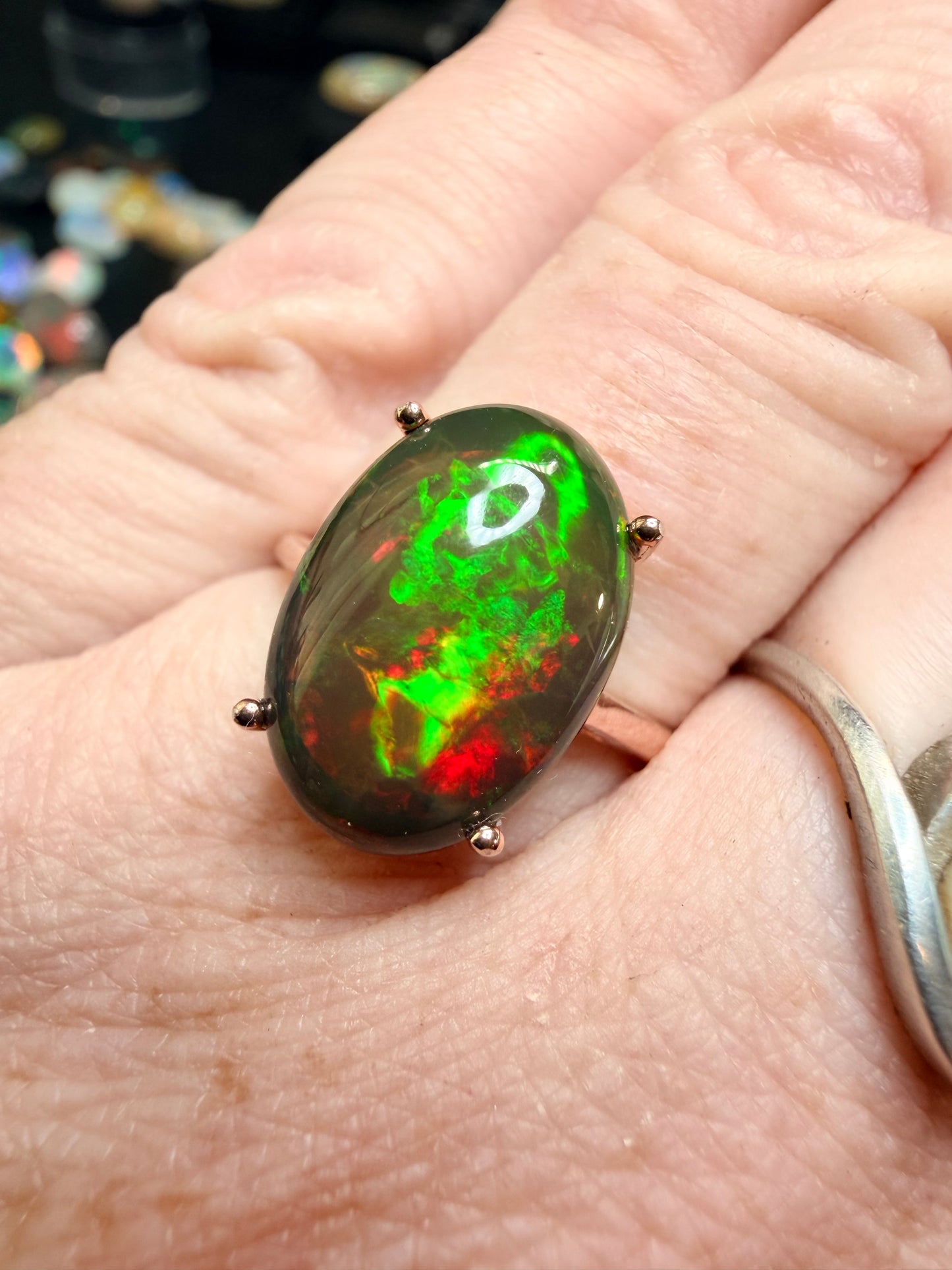 3.5 carat Ethiopian opal adjustable ring in rose gold 925 setting.  Green/orange flash