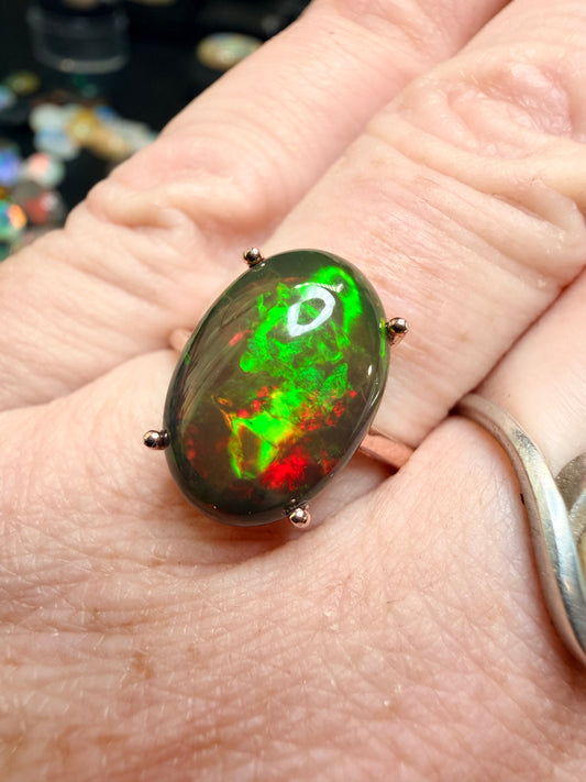 3.5 carat Ethiopian opal adjustable ring in rose gold 925 setting.  Green/orange flash