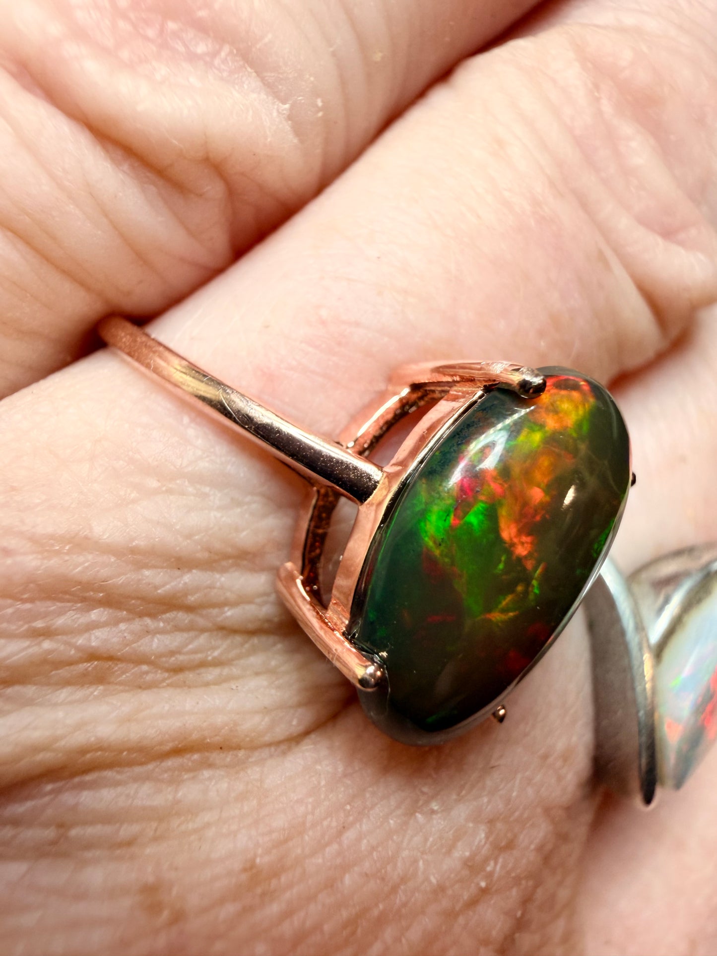 3.5 carat Ethiopian opal adjustable ring in rose gold 925 setting.  Green/orange flash
