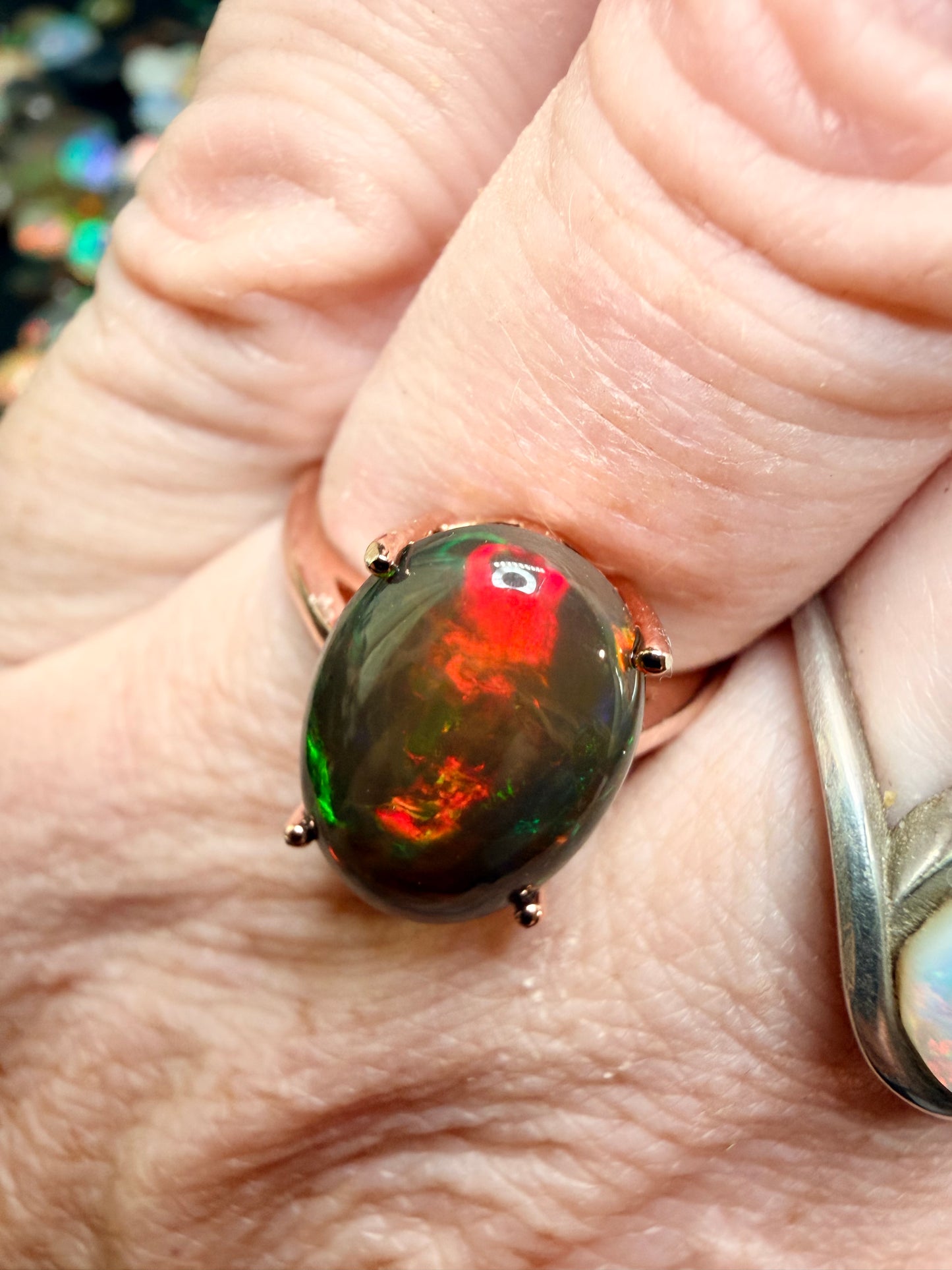 3.5 carat Ethiopian opal adjustable ring in rose gold 925 setting.  Green/orange flash