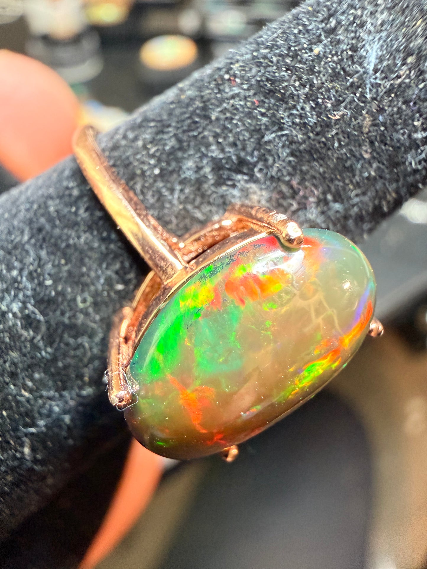 3.5 carat Ethiopian opal adjustable ring in rose gold 925 setting.  Green/orange flash