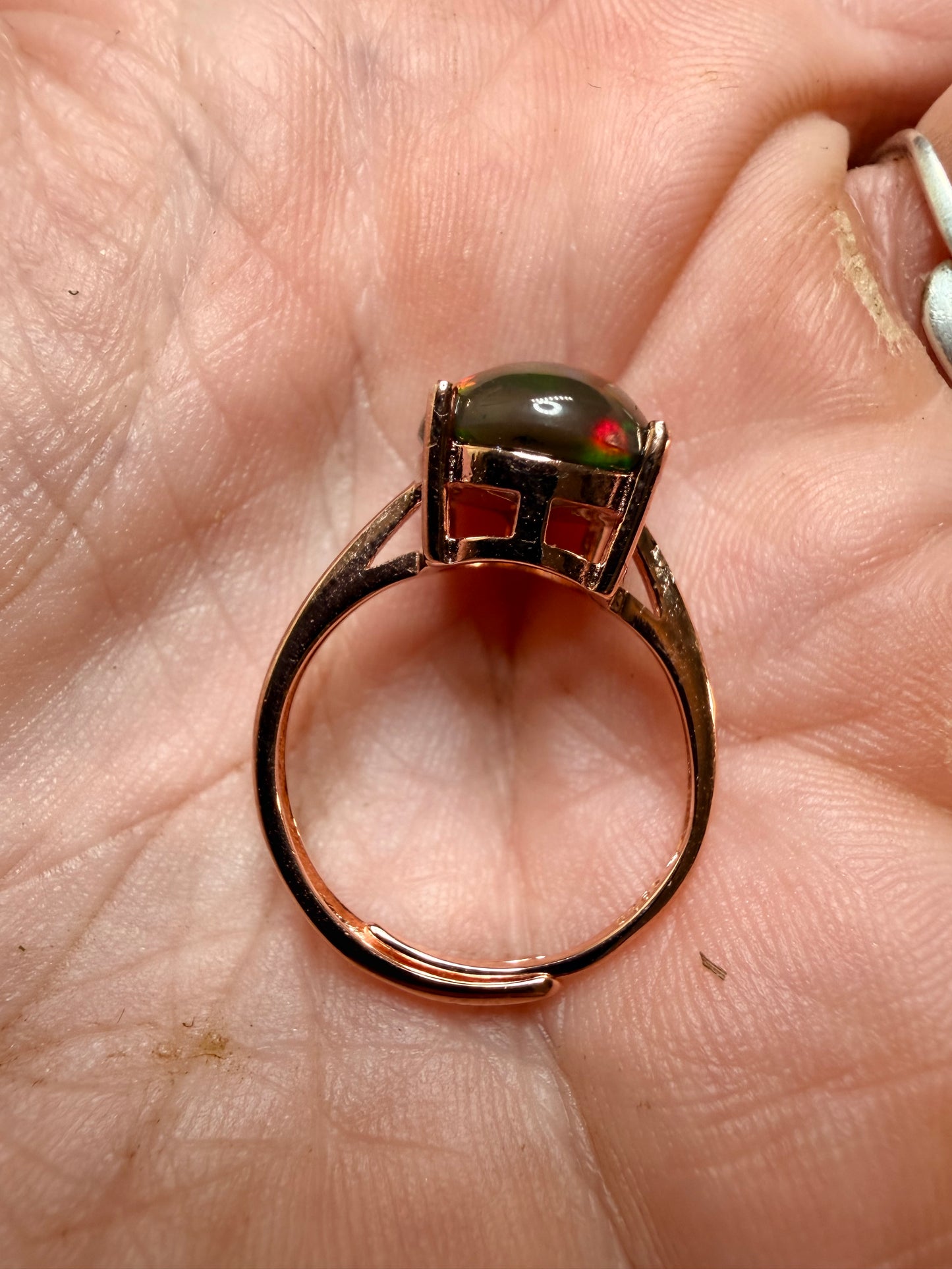 3.5 carat Ethiopian opal adjustable ring in rose gold 925 setting.  Green/orange flash